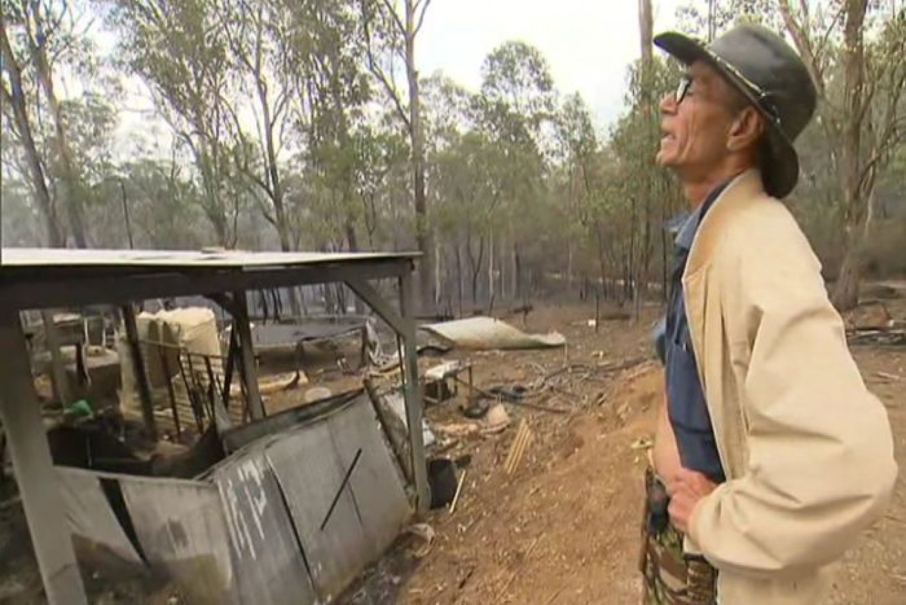 Ron Heperi inspects what is left of his home after the fire swept through.