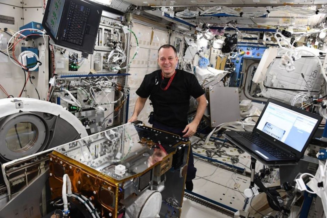 Rick Arnold loads the RemoveDEBRIS spacecraft into an airlock on the International Space Station.

