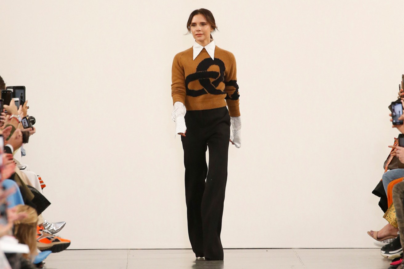Thank you, darlings! Victoria Beckham walks out at the end of her February 17 London Fashion Week show.