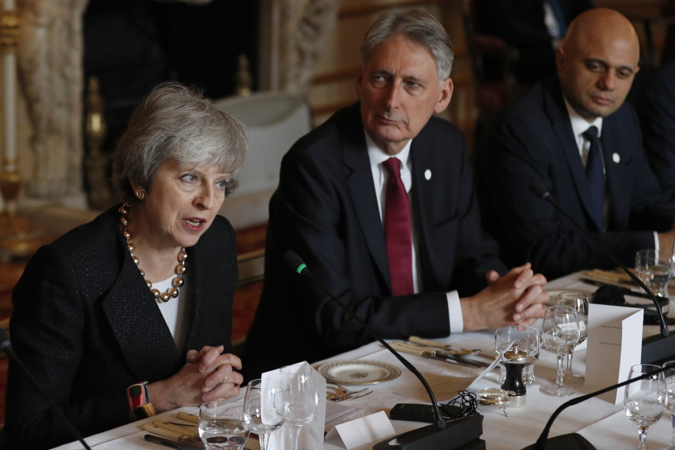 Britain's Chancellor of the Exchequer Philip Hammond (centre) says a Brexit vote could be held'next week'.  