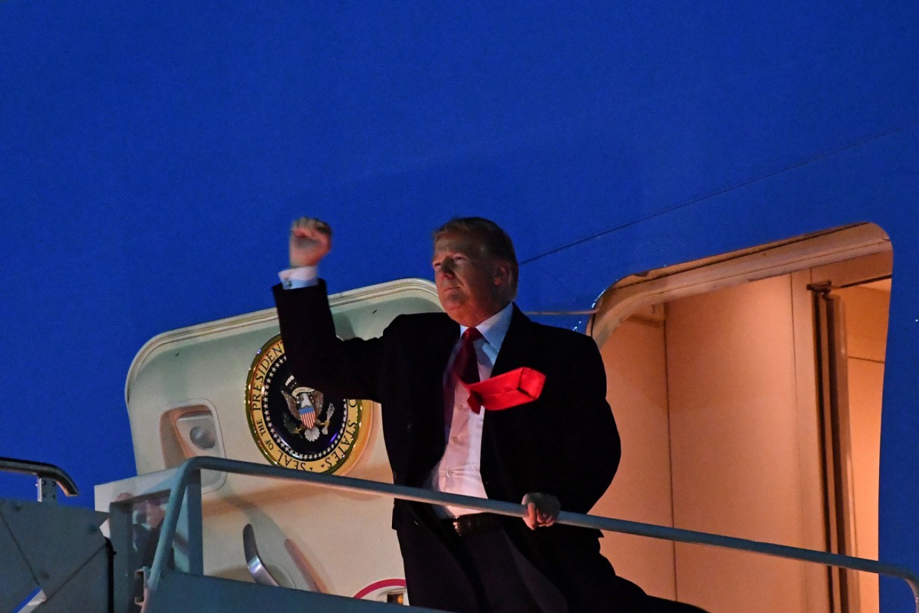 US President Donald Trump waves as he boards Air Force One. 
