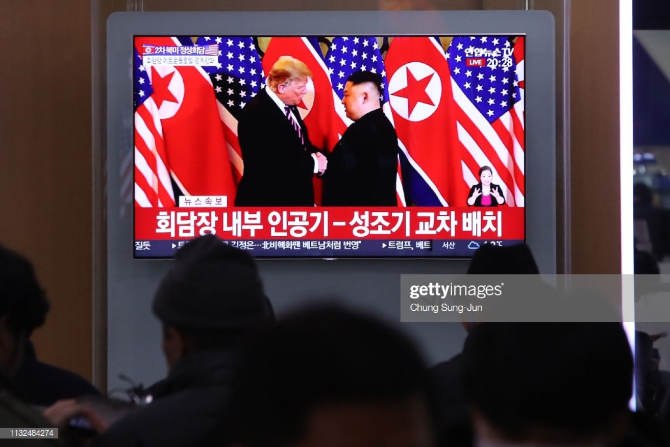 South Korean commuters watch a screen reporting on the   Hanoi summit. 