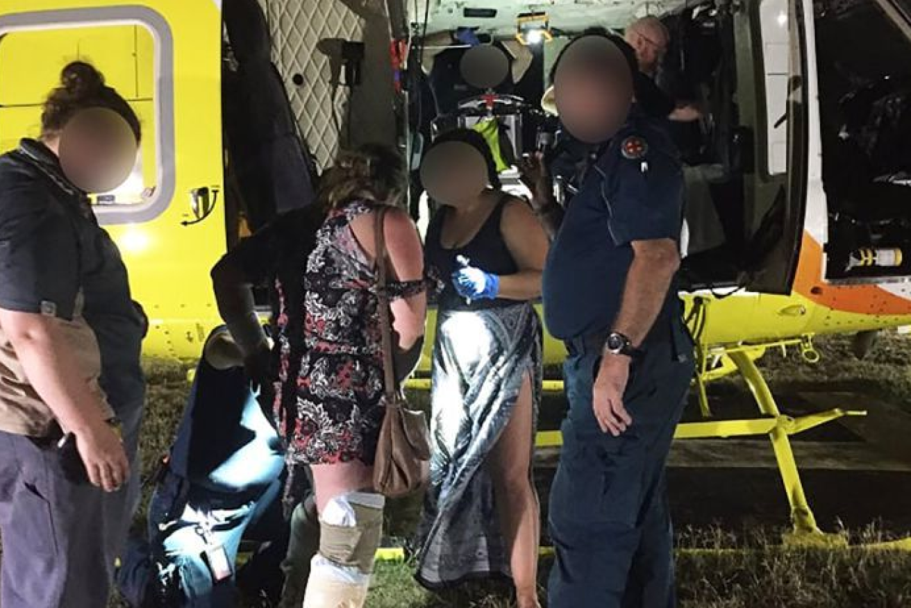 Her leg bandaged, the French mum and her boy are airlifted to hospital from Fraser Island.