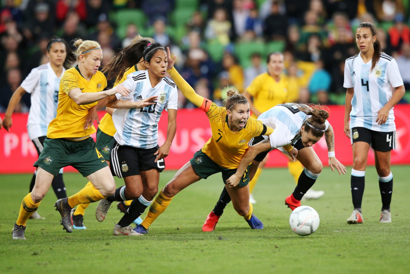 Steph Catley is bowled over to earn Australia an injury-time penalty.   