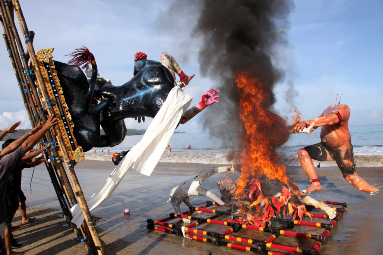 Symbols of evil spirits known as Ogoh-ogoh are cremated during an event on Nyepi eve in Bali. 