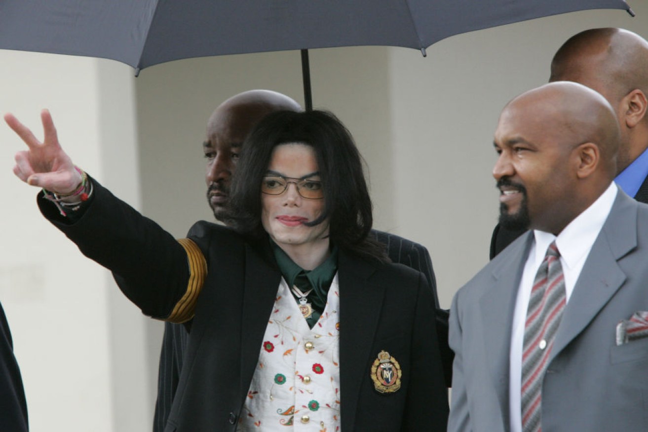 Michael Jackson gestures as he leaves the courthouse during his 2005 trial.