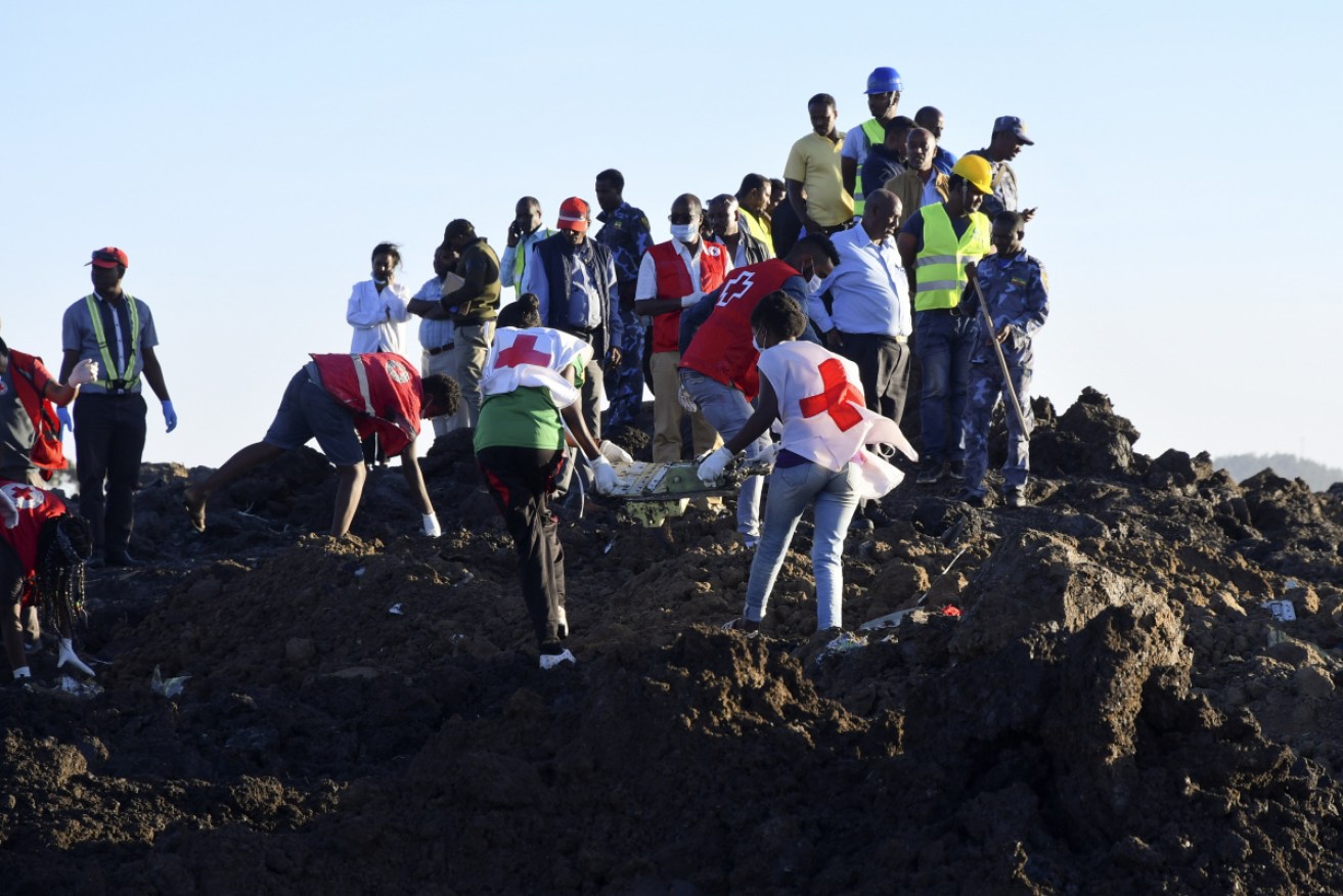 Rescue workers carry wreckage at the crash site of Ethiopia Airlines Boeing  flight.