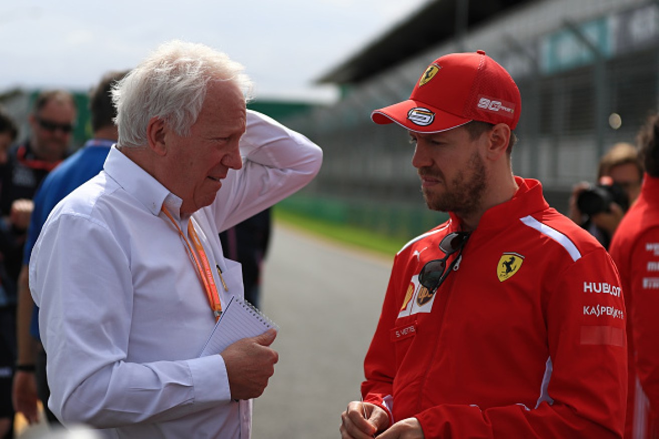 Driver's man: The late Charlie Whiting talks to Ferrari driver Sebastian Vettel as the pair walk the Melbourne track.