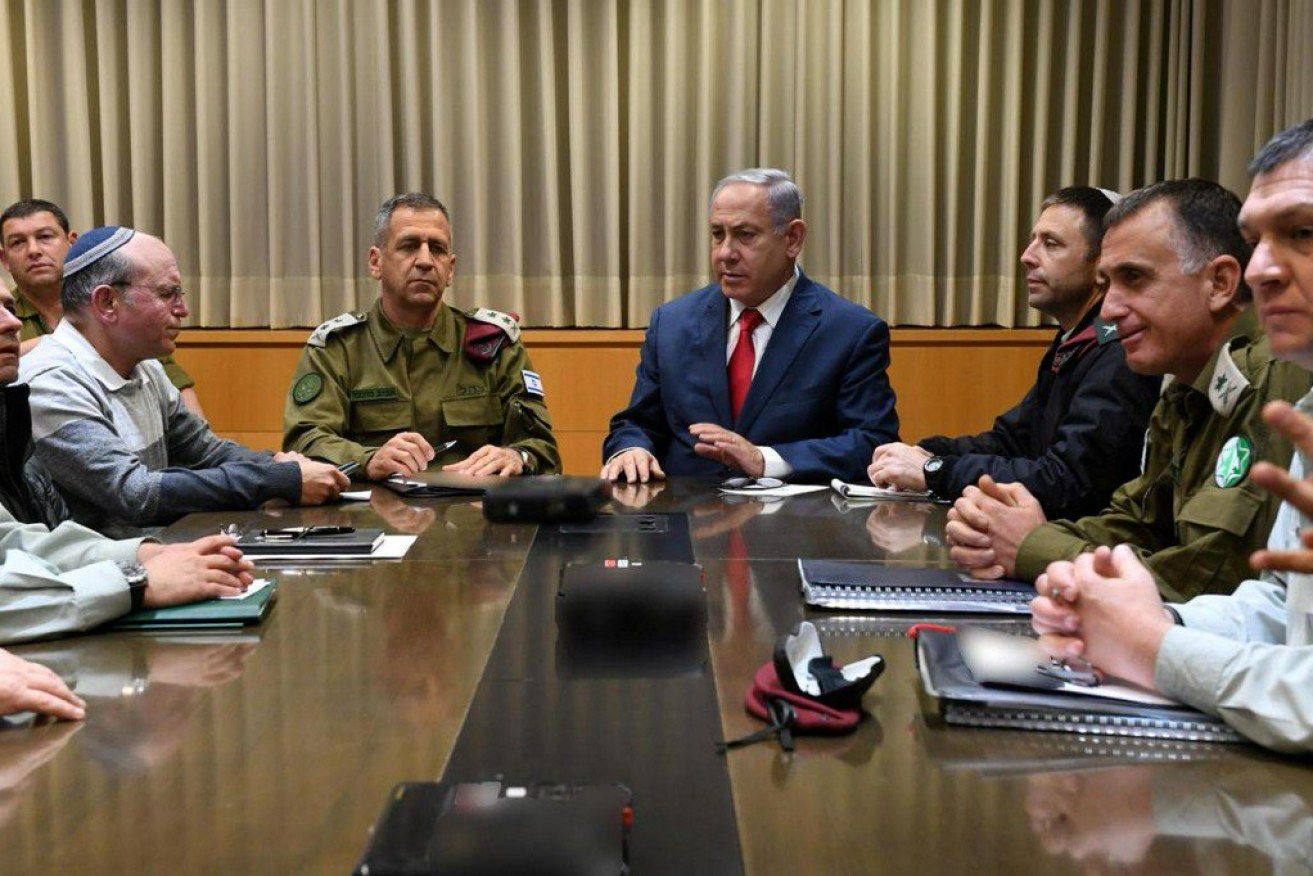 Israeli PM Benjamin Netanyahu, who doubles as defence minister, confers with military and security staff after the attack.