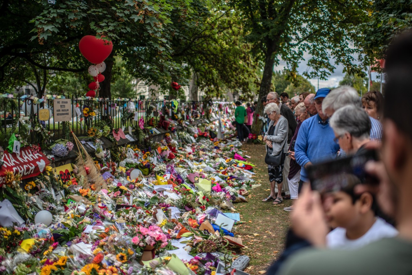 Mourners and a wall of flower in Christchurch following the attack. Photo: Getty