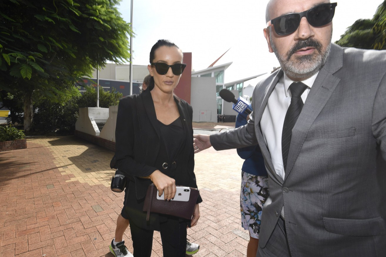<i>Married At First Sight</i> star Ines Basic arrives with a security guard at the Cleveland Magistrates Court in Brisbane on Tuesday.