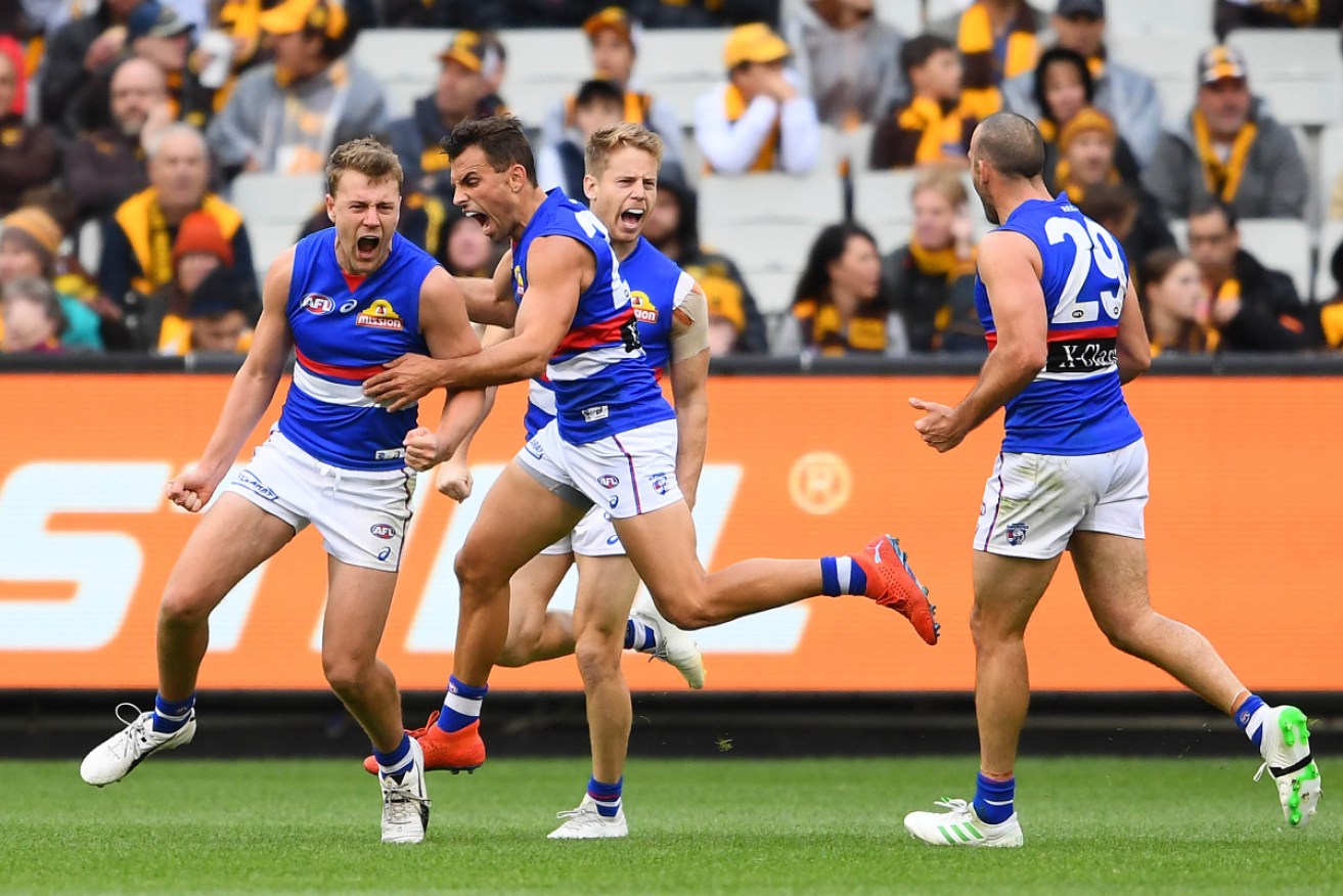 The elation is hard to hide as Western Bulldogs' Jackson Macrae extends their lead against Hawthorn on Sunday. Photo: Getty