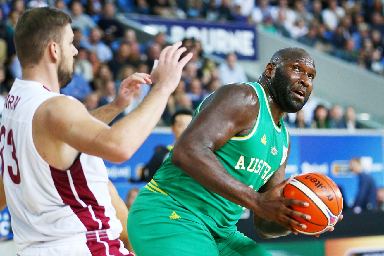 Nathan Leon Jawai of the Boomers shields the ball from Qatar's Emir Mujkic in December in Melbourne.