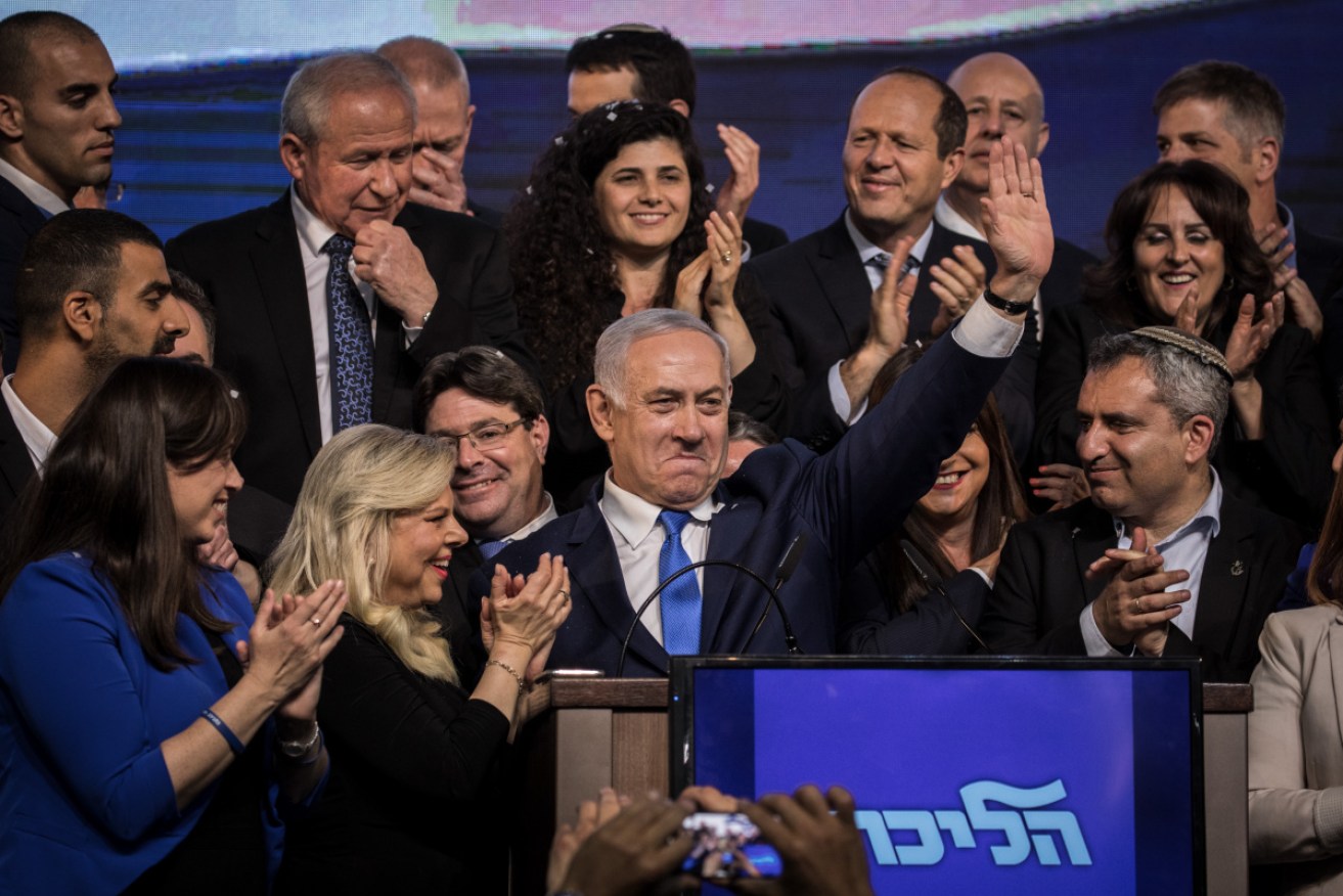 Benjamin Netanyahu (M), Prime Minister of Israel, waves to his supporters at an event after the election.