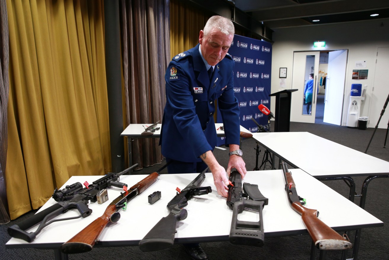 Senior sergeant Paddy Hannon in Wellington looks at guns that are prohibited under the new laws in New Zealand. 