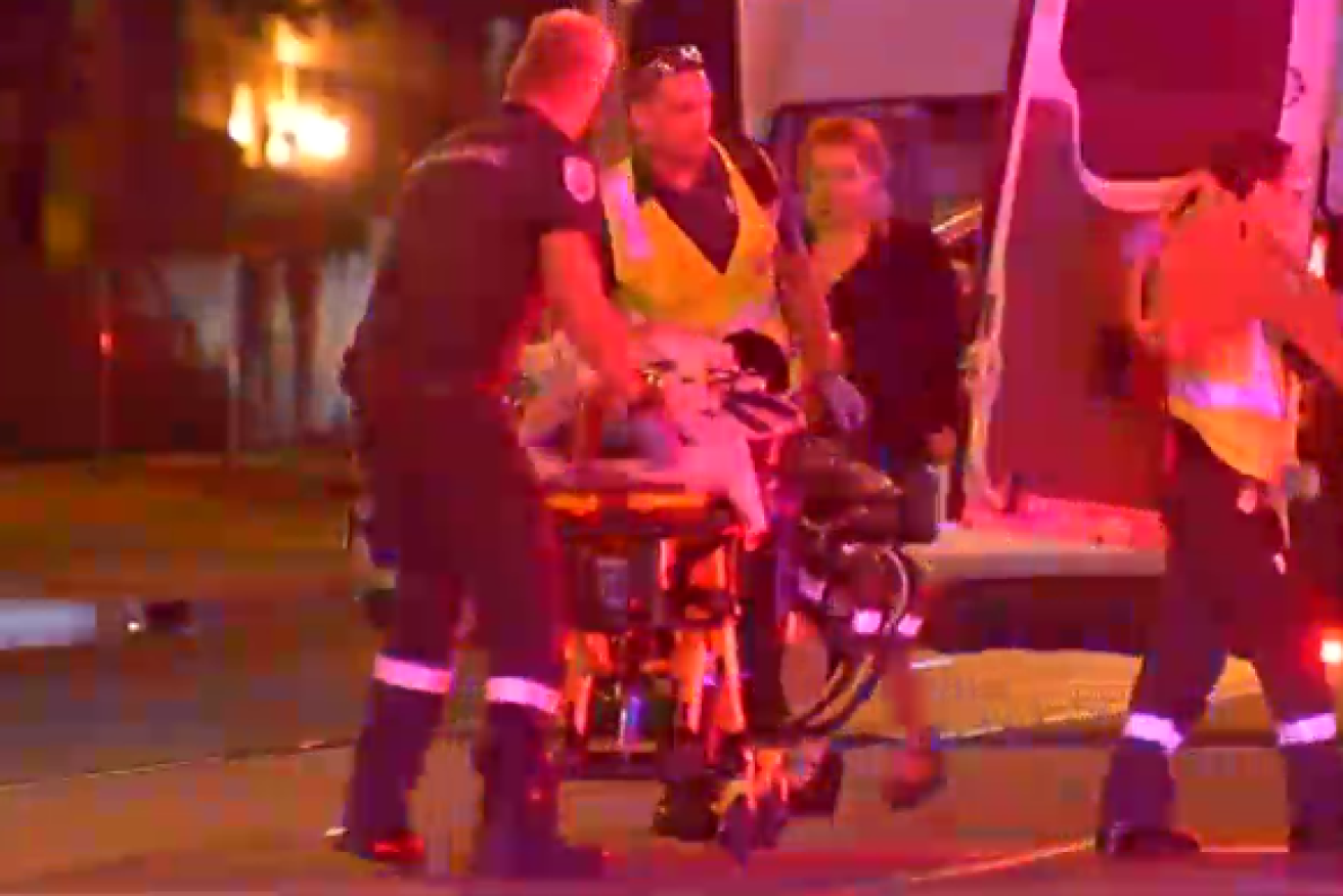 Paramedics speed one of the four shooting victims to hospital.