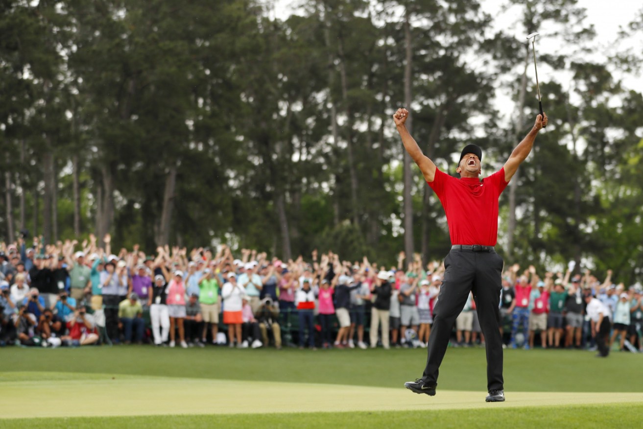 Tiger Woods celebrates his first major victory in 11 years.