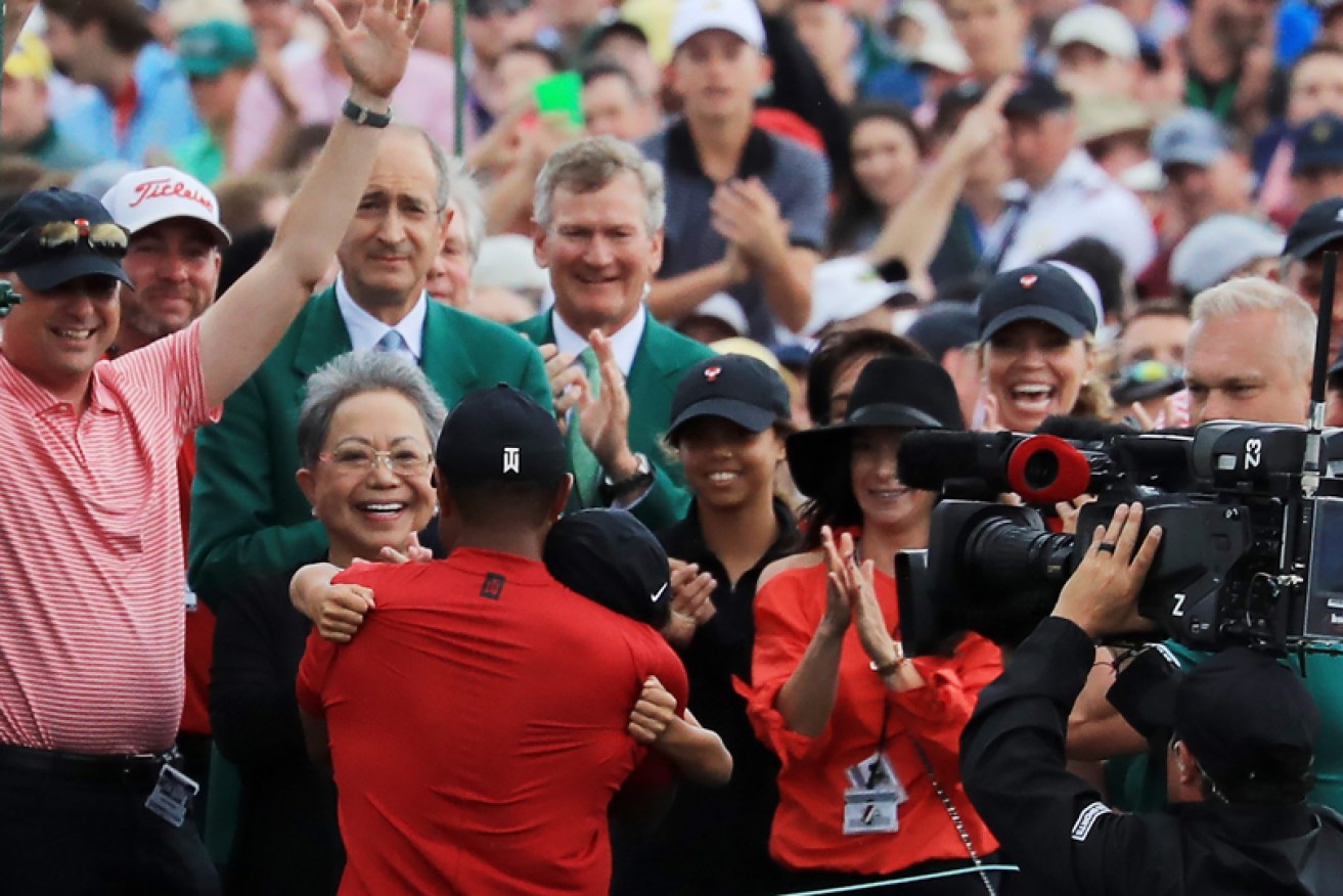 Tiger Woods hugs son Charlie after his Masters win with mother Kultida (left) and daughter Sam.