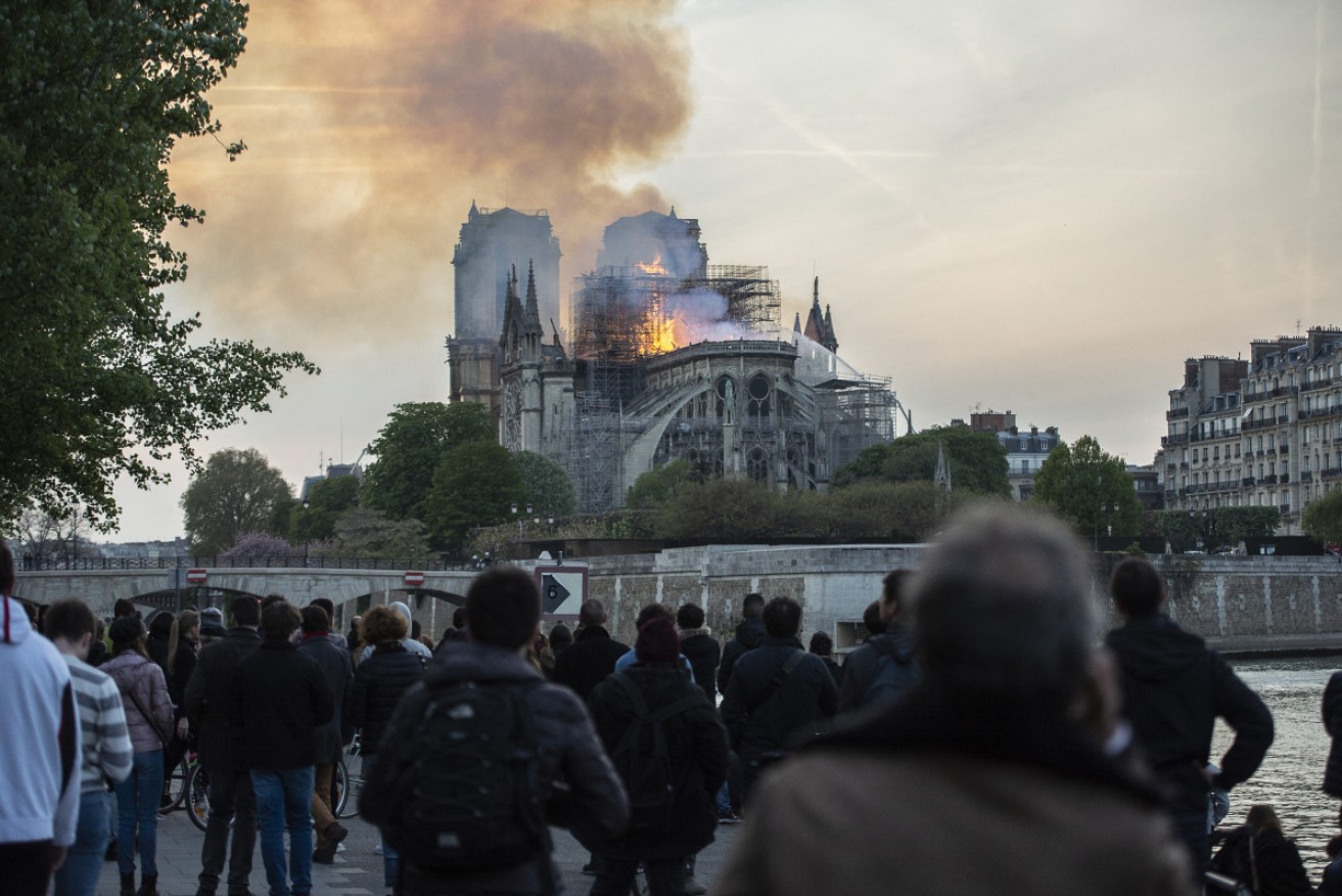 Parisians watch as Notre Dame burns.