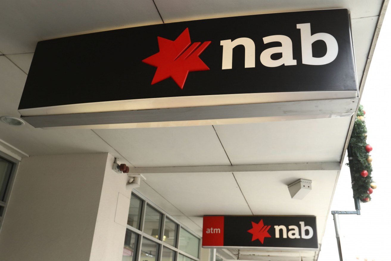 NAB has slashed its payout as the bank's full-year profit dropped 10.6 per cent to $5.1 billion.