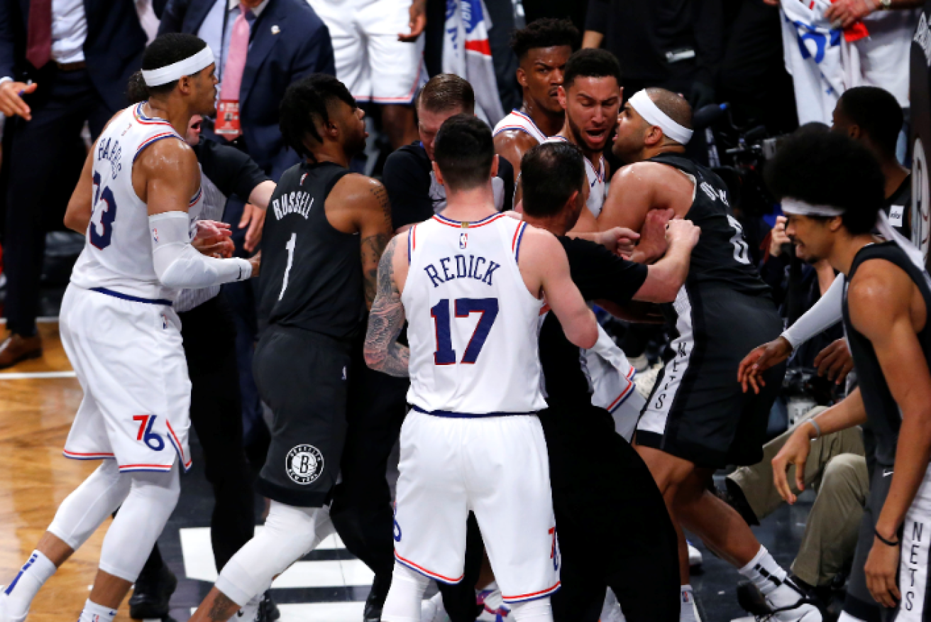 Push comes to shove under the net as Ben Simmons and Nets forward Jared Dudley face off. 