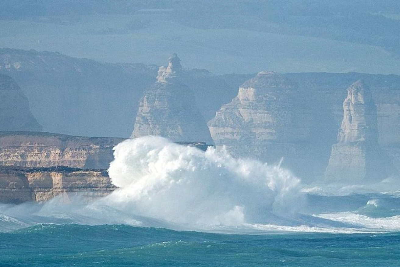 Gigantic waves pound the Victorian coast where two rescuers lost their lives.