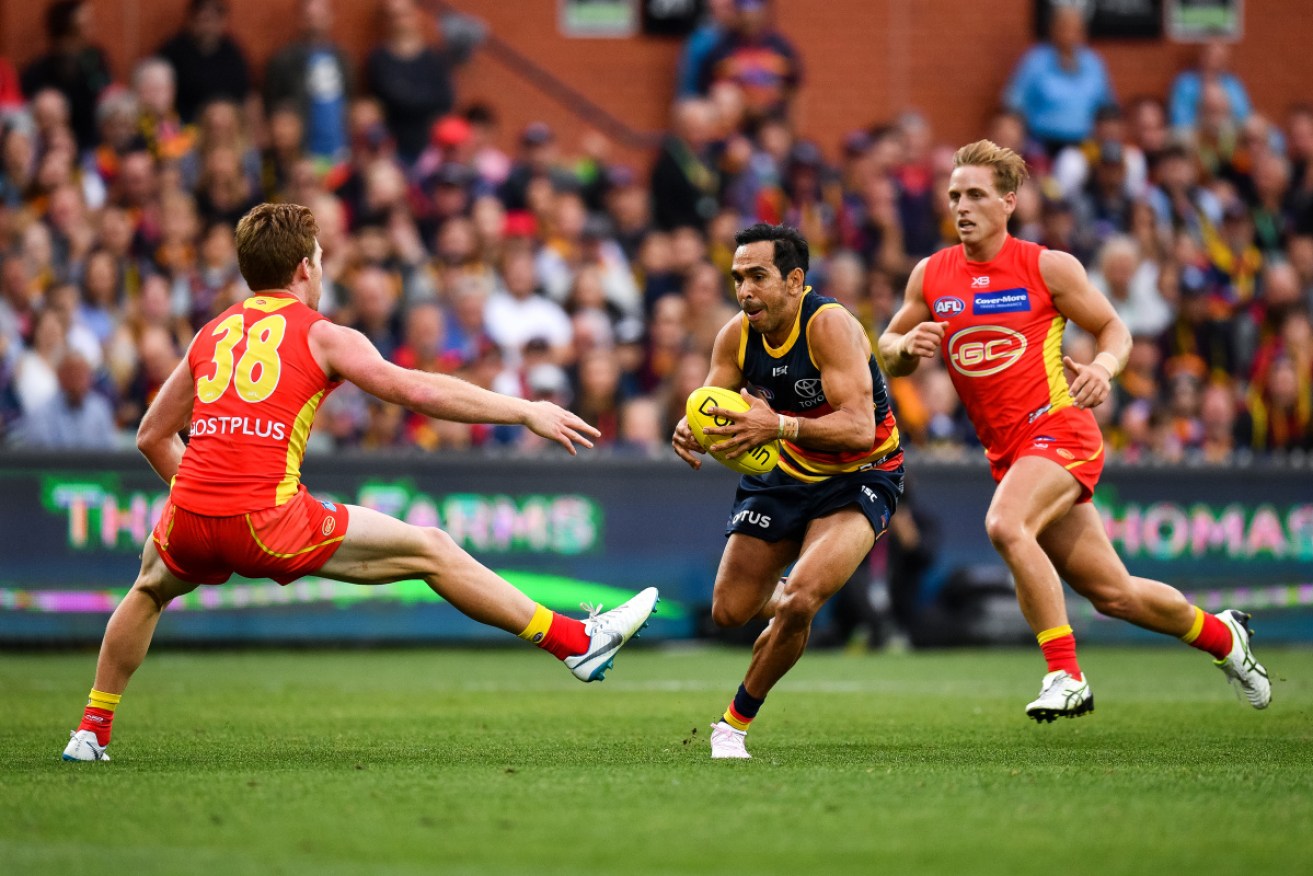 Adelaide's Eddie Betts doing what he does best against Gold Coast's Jesse Joyce on Sunday. 
