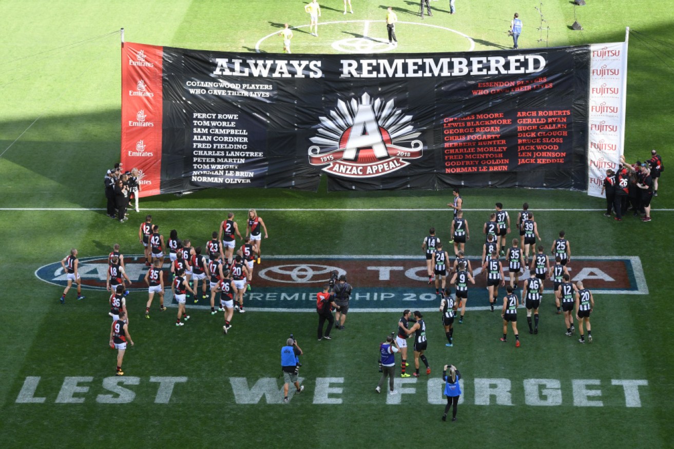 Essendnon and Collingwood players on the field before last year's ANZAC Day match at the MCG. 