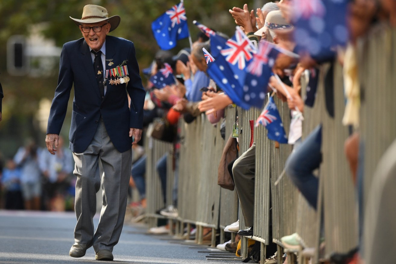 An ex-serviceman marches in the Sydney parade, attended by thousands.