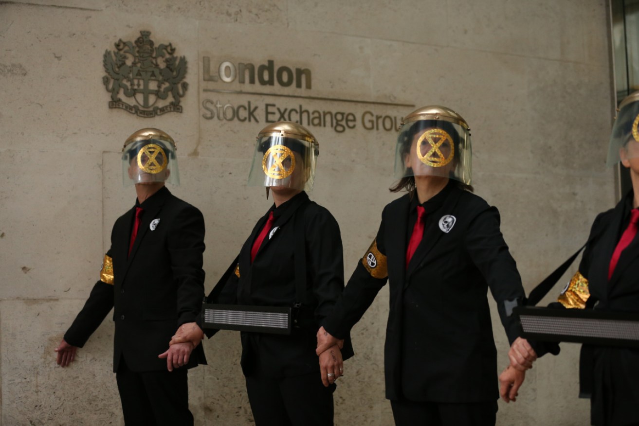 Extinction Rebellion protesters glue themselves to the entrances of the London Stock Exchange on Thursday. 