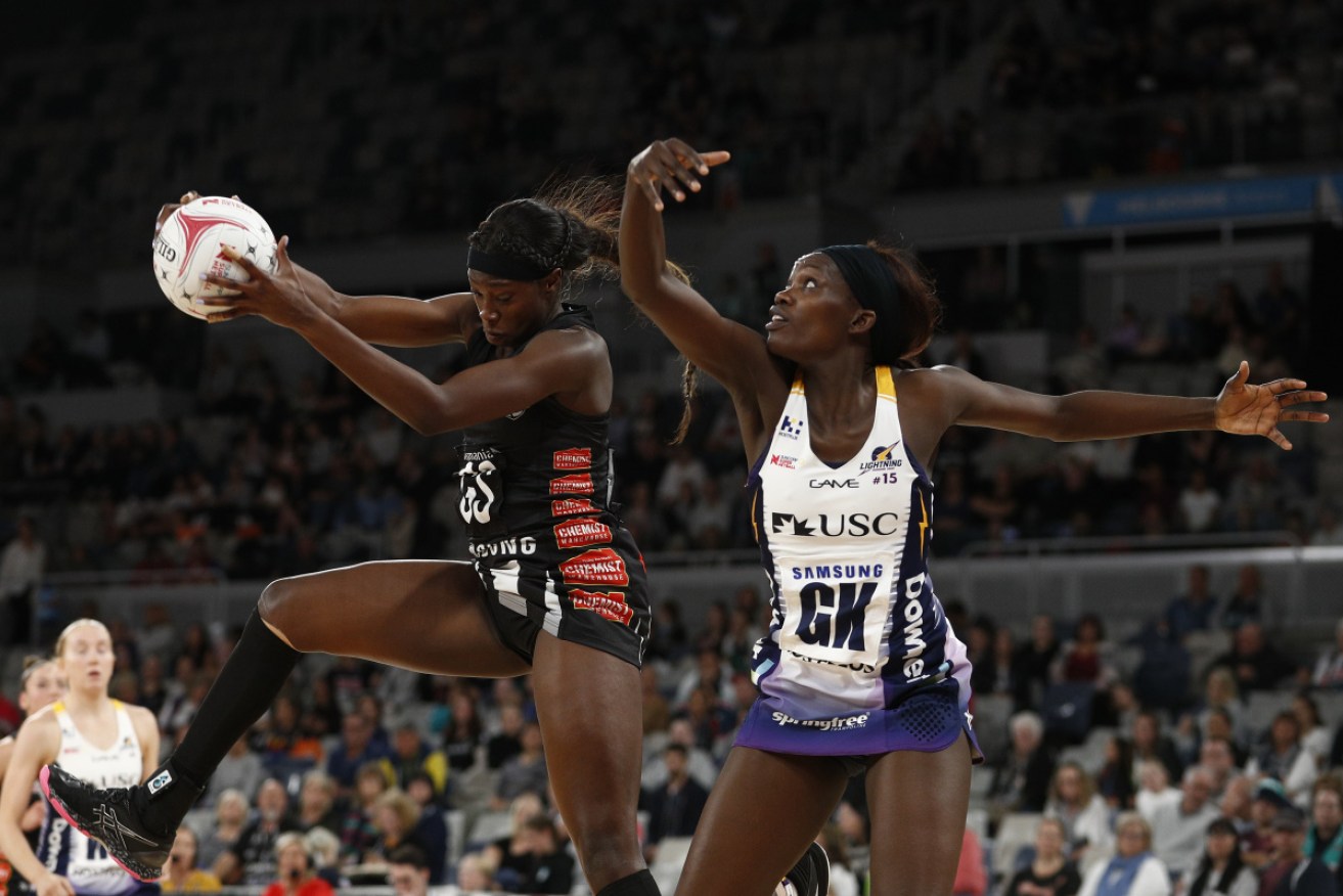 Shimona Nelson of the Magpies and Phumza Maweni of the Lightning contest the ball during the opening of the Super netball season. 