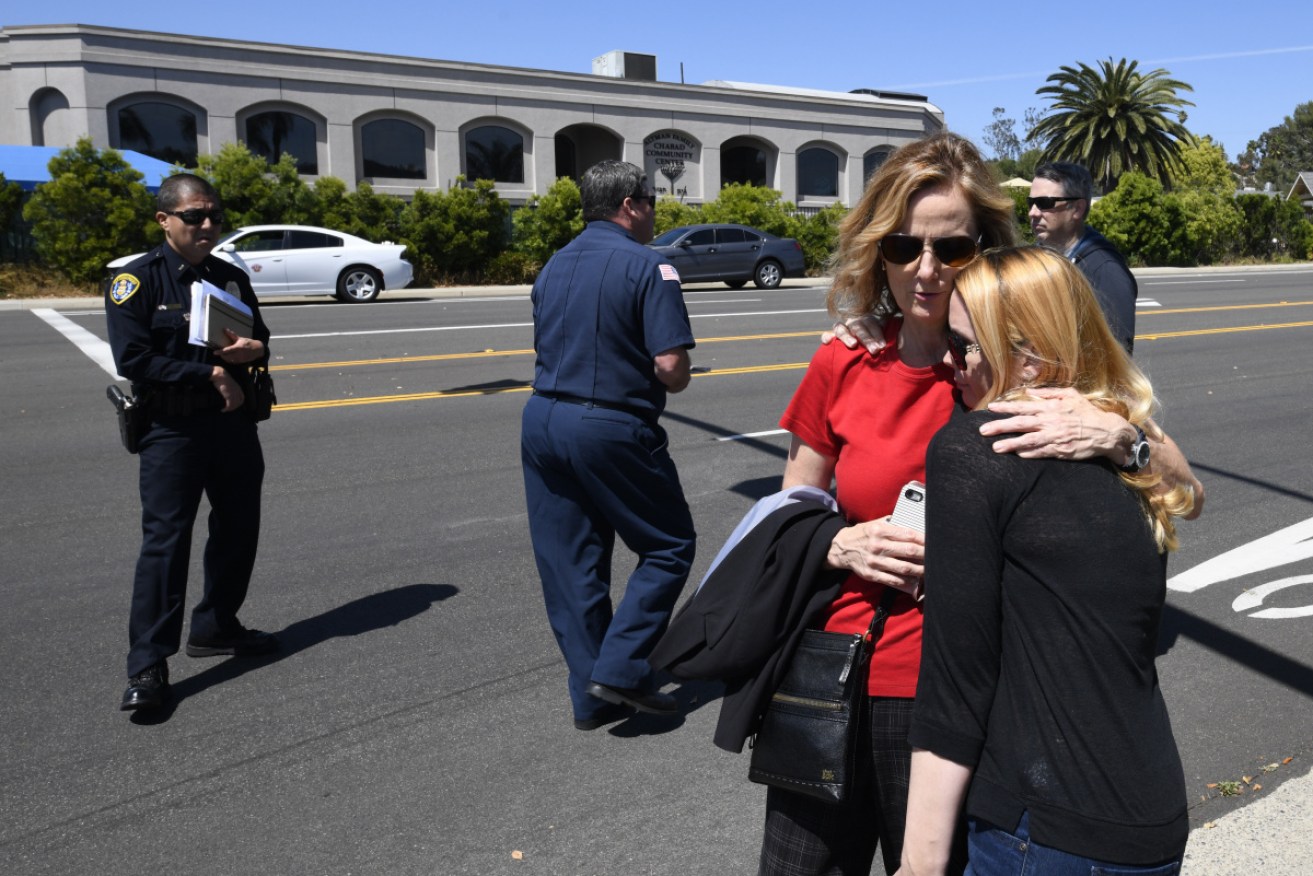 Two shaken survivors find comfort in each other's arms after the attack on San Diego's Chabad of Poway Synagogue .