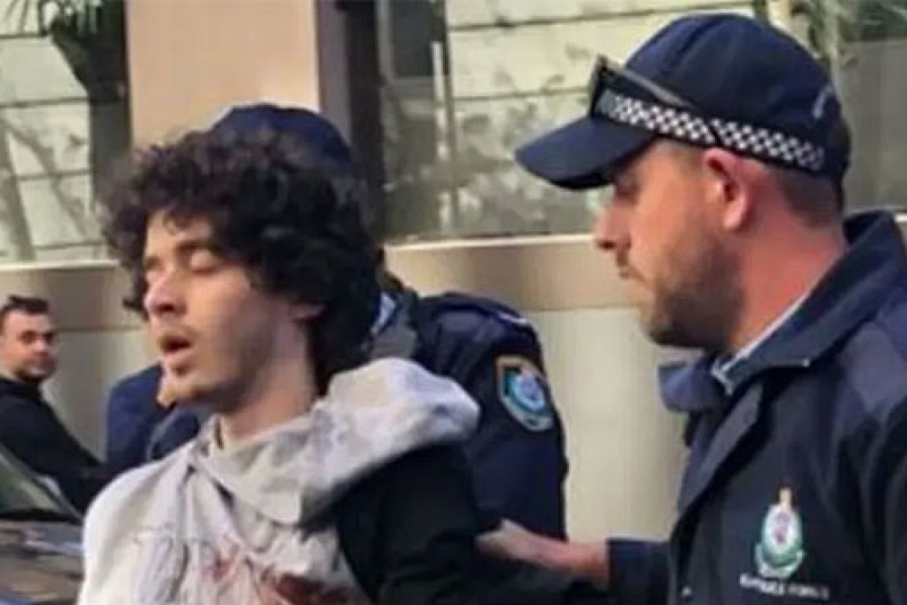 Mert Ney is taken away by NSW police after terrorising the Sydney CBD.