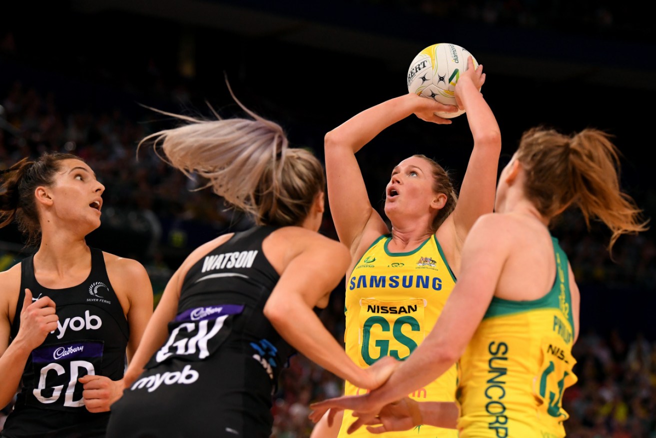 Milestone: Caitlin Bassett of Australia under pressure from Silver Fern players in the last match.