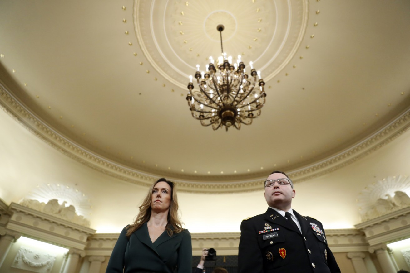 Jennifer Williams, an aide to Vice President Mike Pence, and National Security Council aide Lt. Col. Alexander Vindman stand as they take a break in hearing before the House Intelligence Committee.