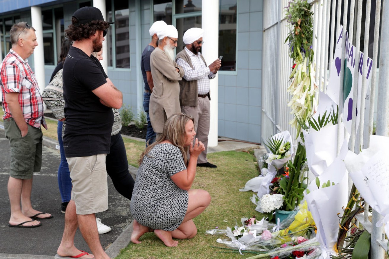 Mourners lay flowers near the site of the cruise ship on which tourists had been travelling before the volcano eruption. 