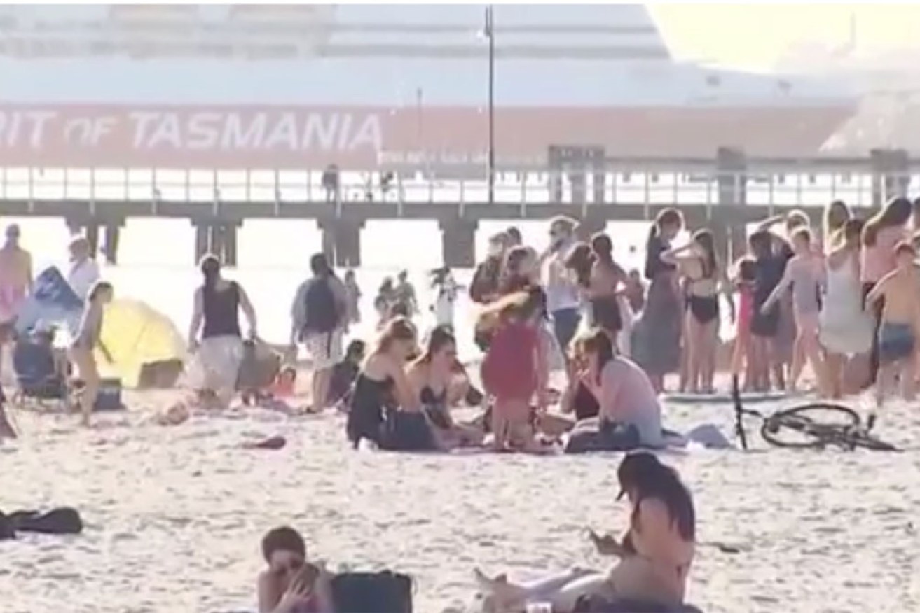 Large crowds gathered outdoors in Melbourne's warm sunshine despite strict restrictions still in place.