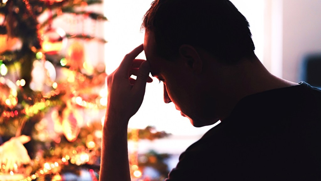 pictured is someone upset near Christmas tree