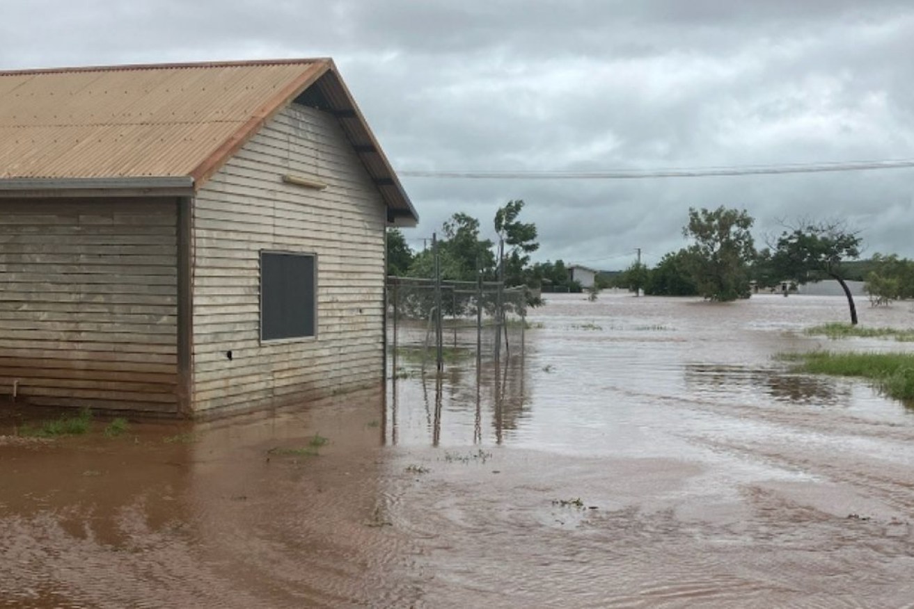 Floodwaters lap homes in the remote NT community of Kalkarindji.