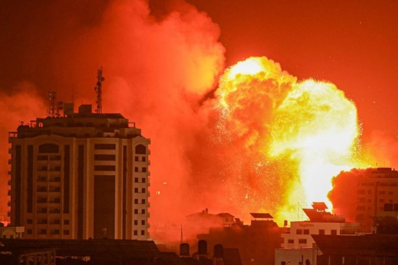 Flames light up a night of destruction in Gaza after another Israeli strike.