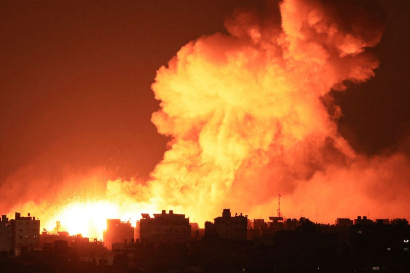 Fire and smoke rises from buildings following Israeli airstrikes on Gaza City.