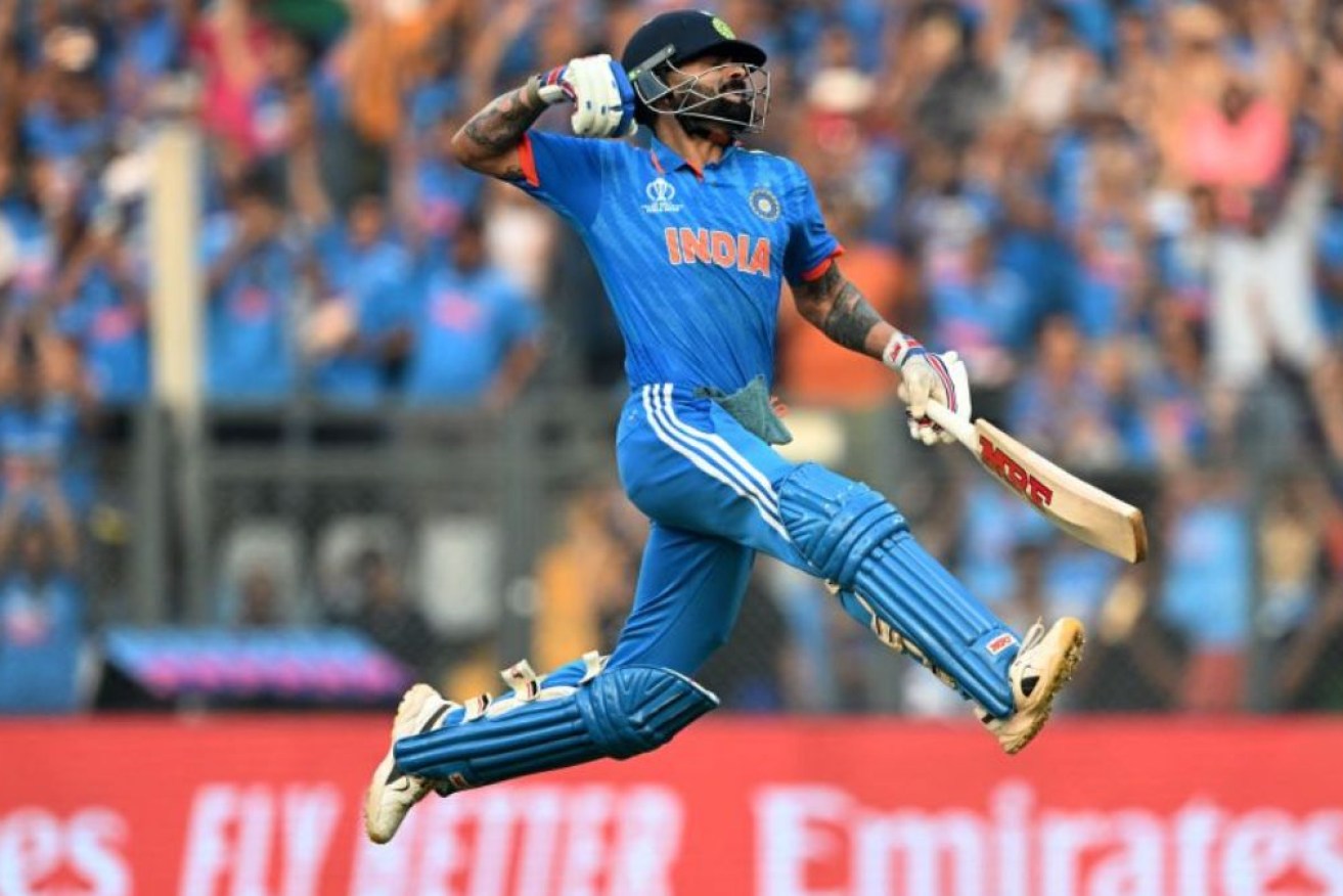Virat Kohli celebrates a cricket milestone in the clash against New Zealand.