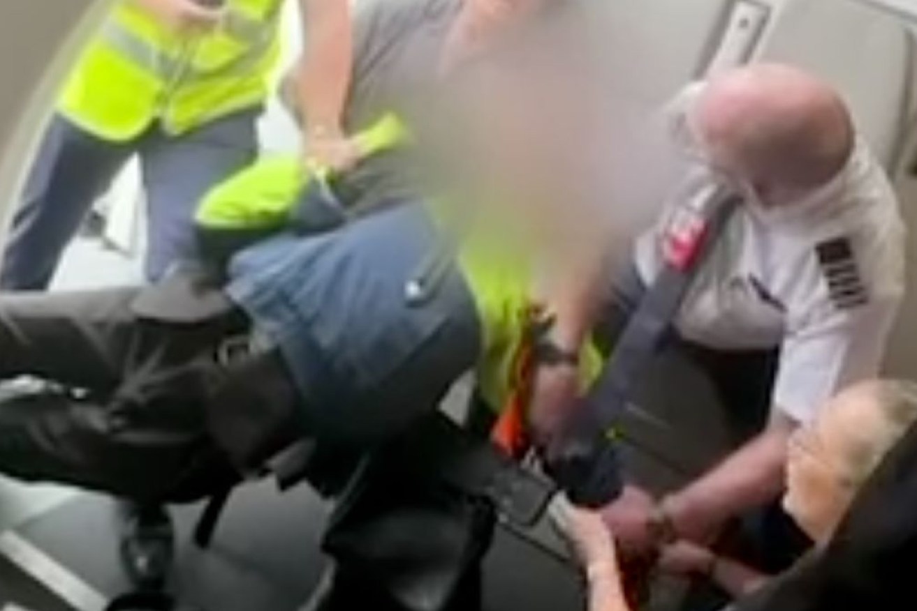 A teenager has been arrested after he was tackled trying to board a plane amid fears he had a gun.