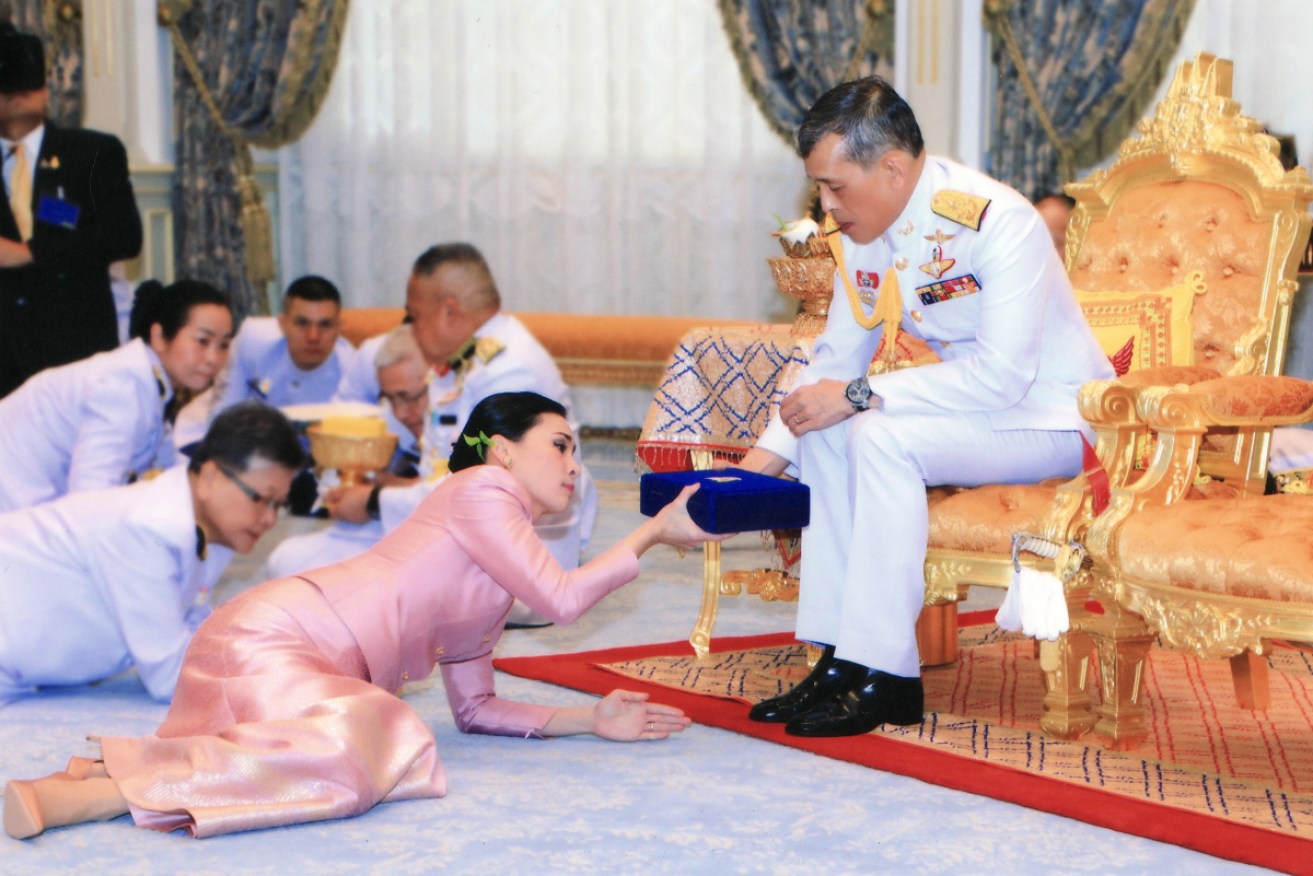 King Maha Vajiralongkorn and his queen, Suthida, during Wednesday's royal order.