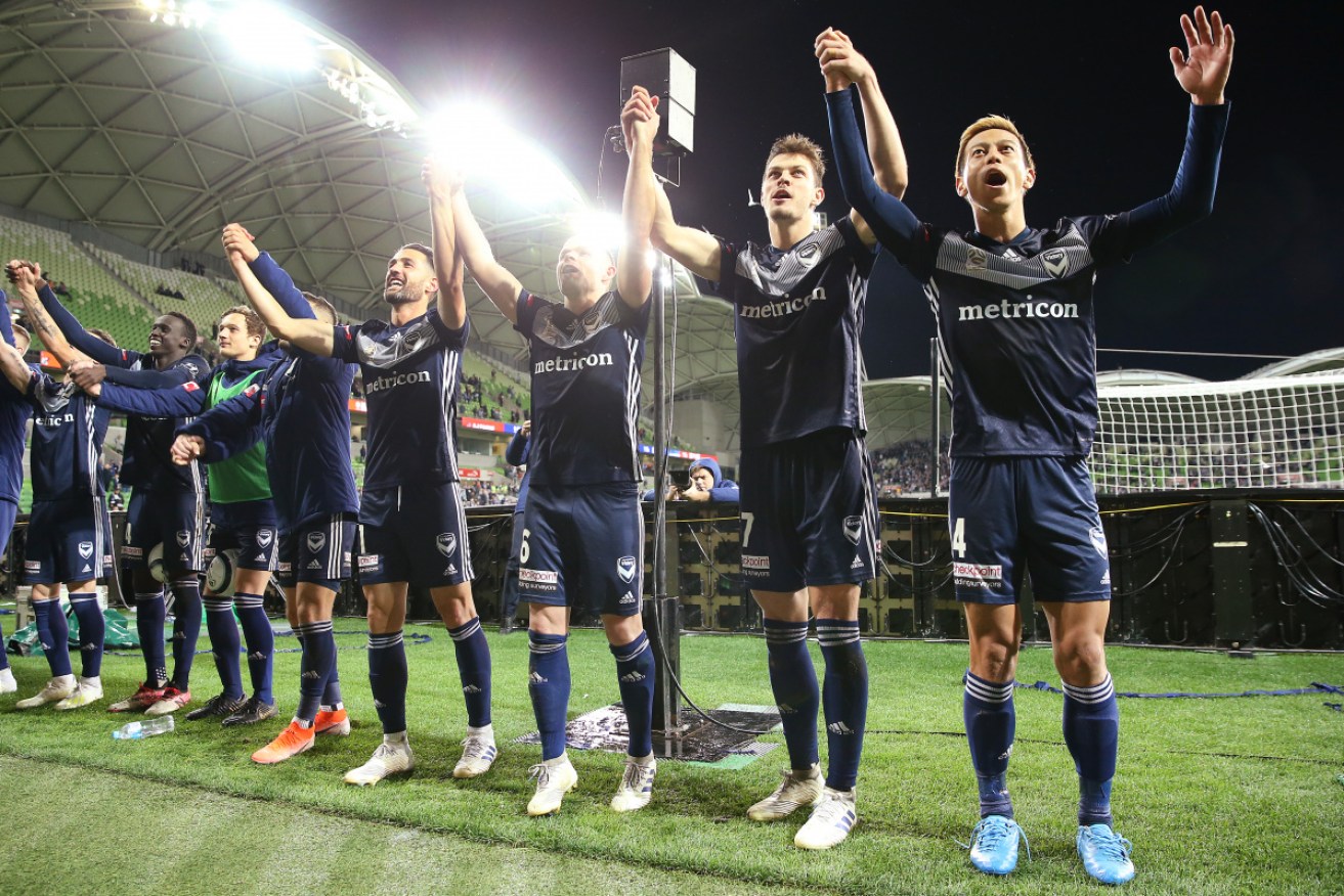 Melbourne Victory players celebrate their win in the elimination final on Friday night. 