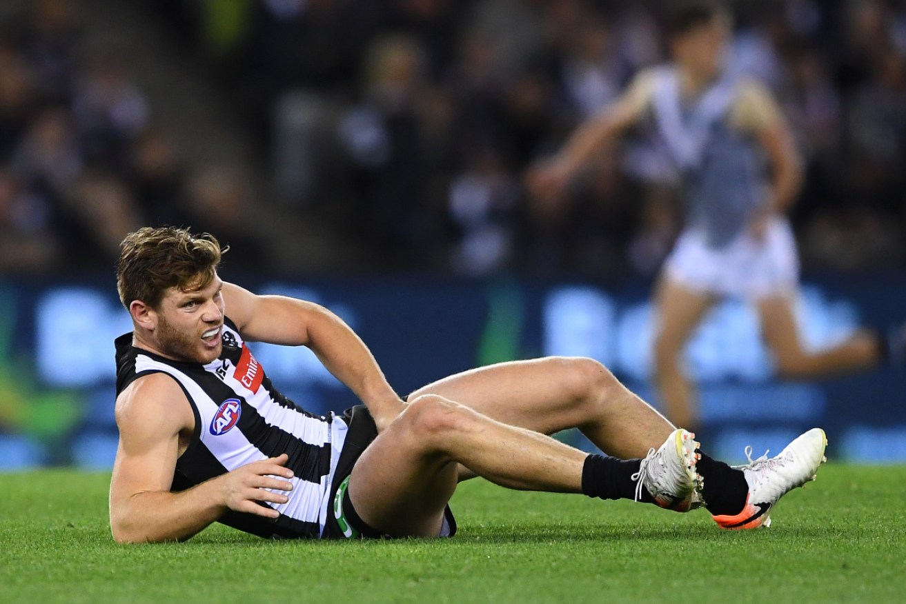 Collingwood's Taylor Adams hits the deck during the match against Port Adelaide. 