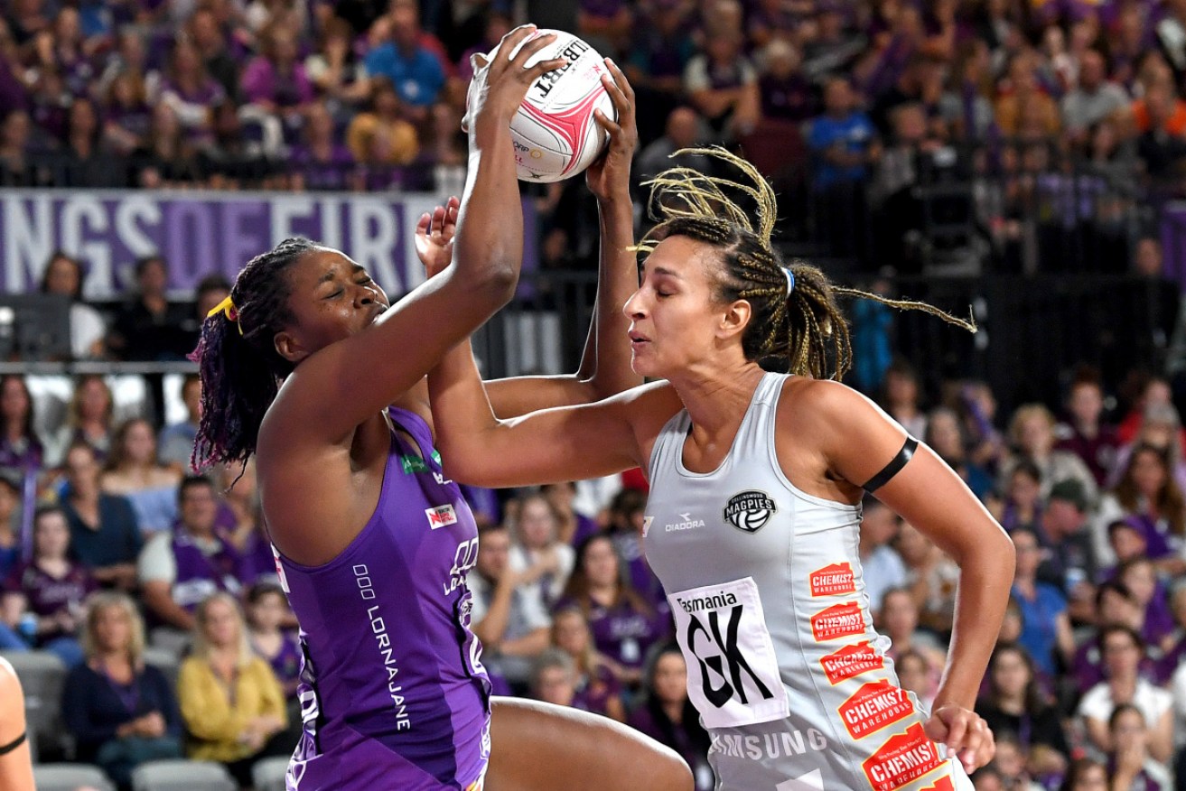 Tough in the clinches for Romelda Aiken of the Firebirds and Geva Mentor of the Magpies.  
