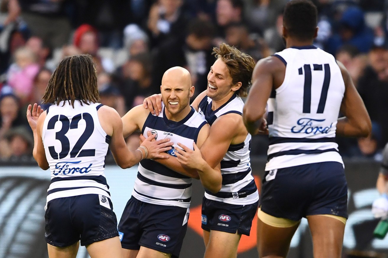Gary Ablett is congratualted by teammates after kicking a goal at the MCG. 