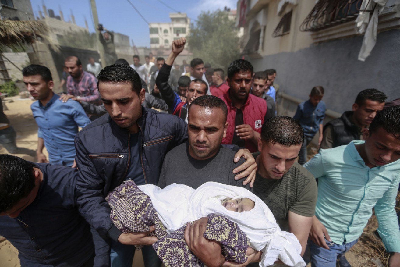 Palestinian mourners carry the body of Seba Abu Arar during her funeral in Gaza City.
