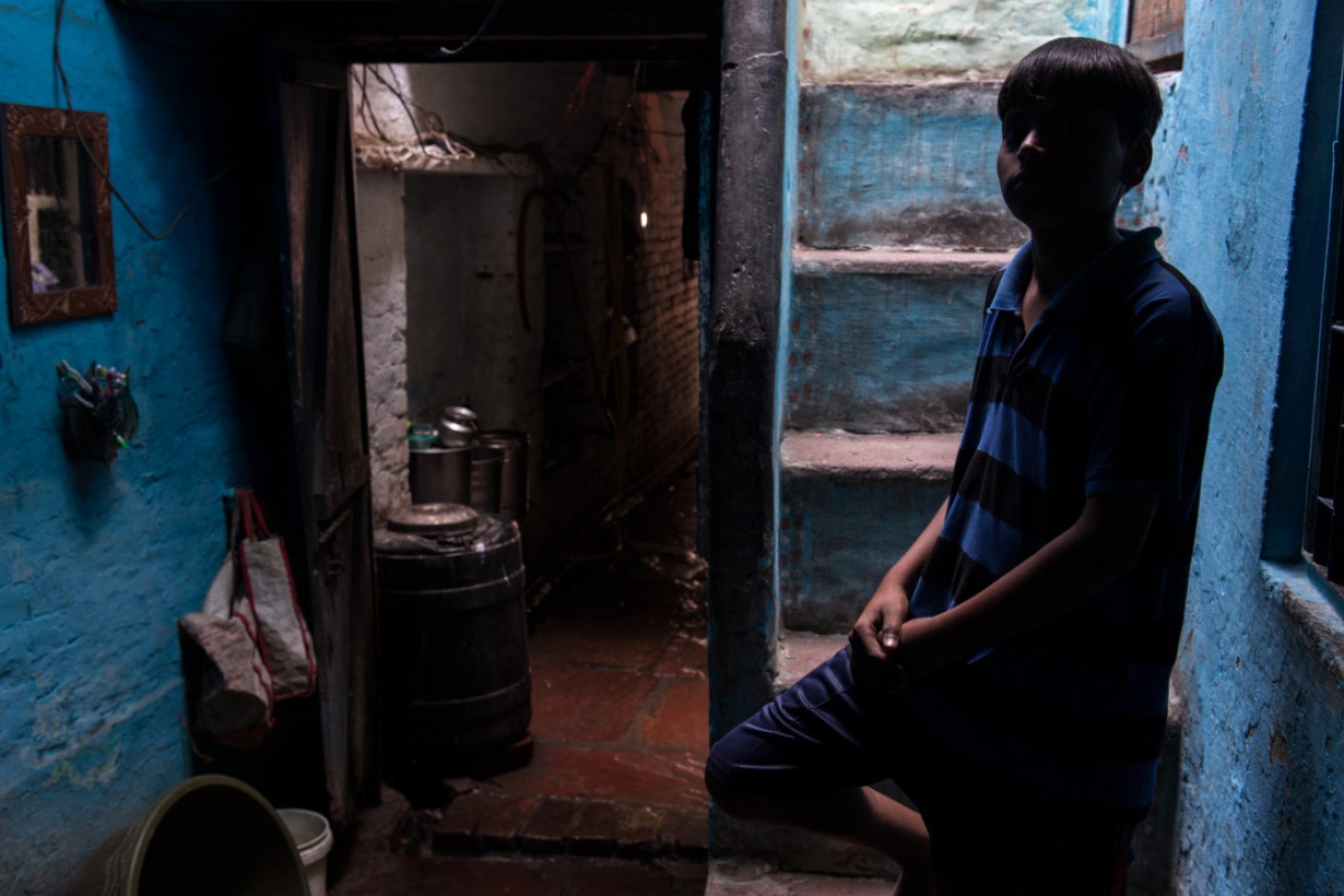 13-year-old Jatin in his home in Agra, India.